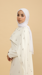 white cape dress with sleeves and embellishments 
